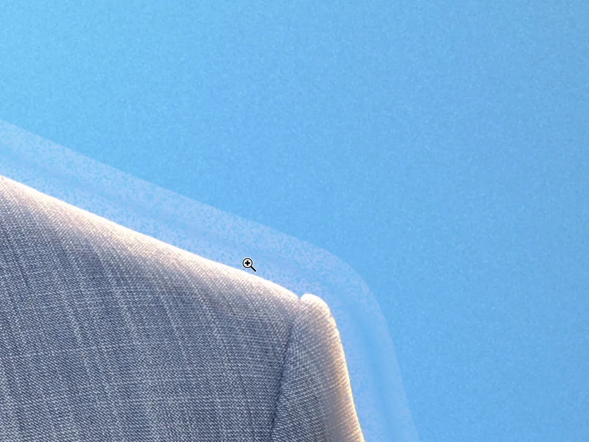 A close-up of the bright halo a rim light left along the shoulder of a jacket, before masking