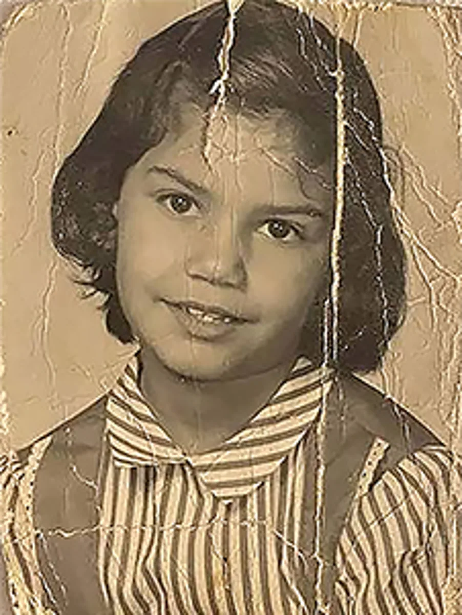 Creased faded child portrait restored to colour by Radbin — before
