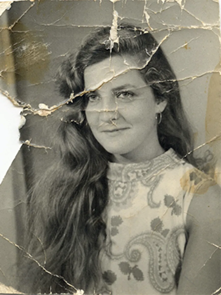 Torn black and white portrait restored by Radbin — before